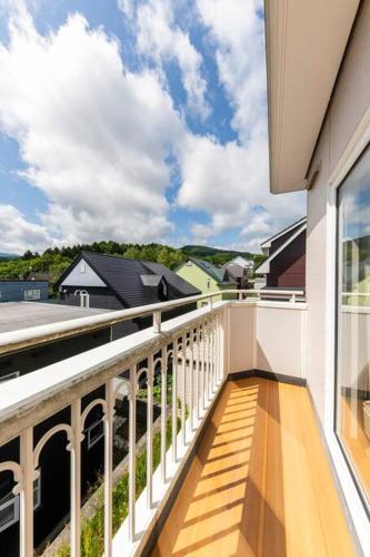a balcony with a view of a house at Warabe in Otaru