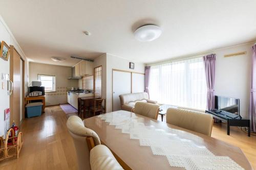 a living room with a dining table and a living room with at Warabe in Otaru