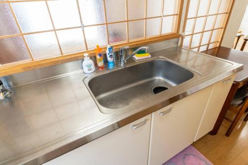 a stainless steel sink in a small kitchen at Warabe in Otaru