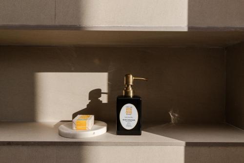 a bottle of soap on a shelf in a bathroom at Zhiwaling Heritage in Paro