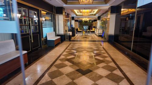 a hallway with a checkered floor in a building at Kay Hotel and Residences in Angeles