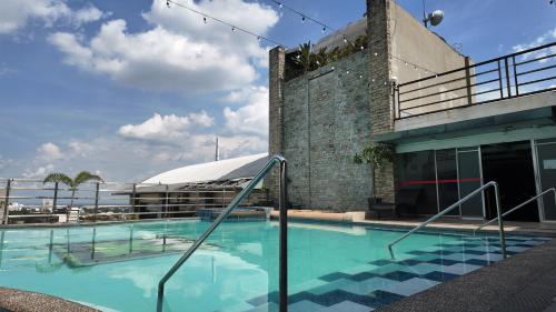 a large swimming pool next to a building at Kay Hotel and Residences in Angeles
