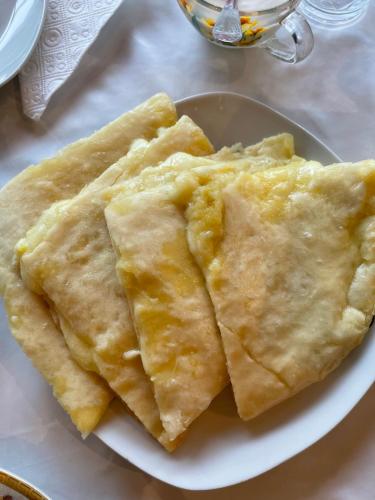 a plate of empanadas sitting on a table at GuestHouse NaSHGOBI in Ushguli