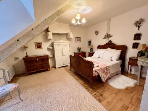 a bedroom with a bed and a staircase at La Petite Madeleine is a Charming 2 Bedroom Pet Friendly Gite situated on Dinan Port in Dinan