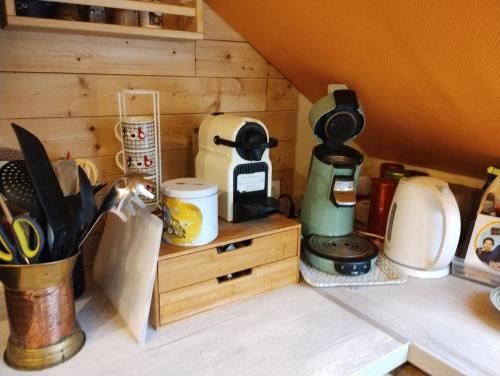 a kitchen counter with a coffee maker and other appliances at La belle étape bercéenne au calme de sa campagne près circuit Mans Sud in Marigné-Laillé