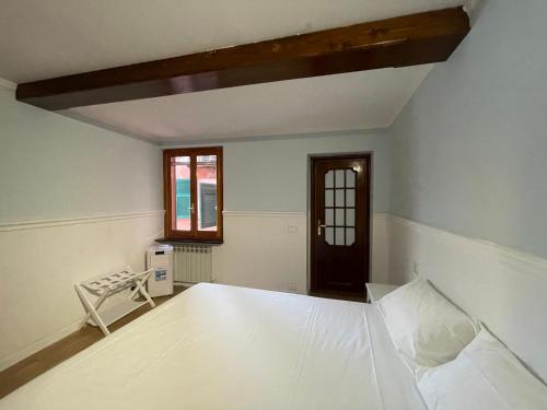an empty room with a bed and a window at The First Colombo Brignole XX Settembre in Genoa