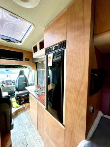 an interior view of an rv with a kitchen at Kampervan do wynajęcia in Wilków-Osiedle