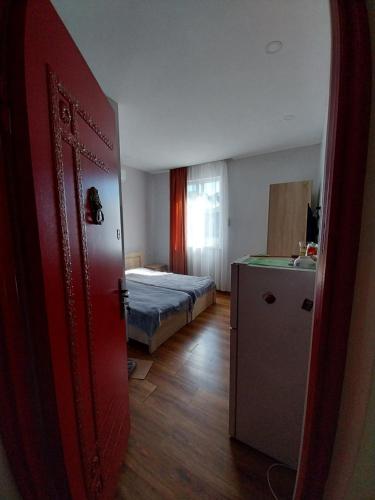a room with a bedroom with a bed and a door at Sweet studio with all amenities in Batumi