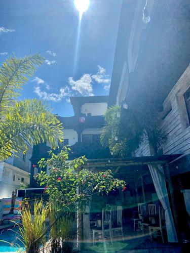 a view of a patio with chairs and trees at Le Pôle in Grand Baie