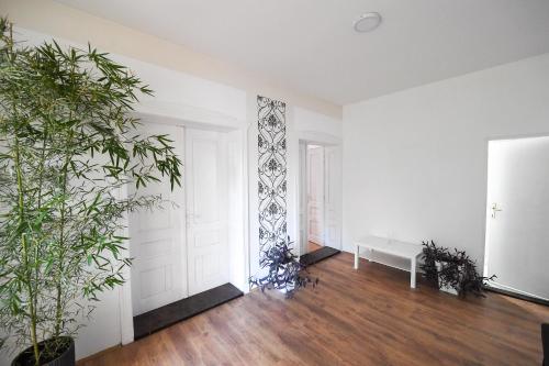 an empty room with plants and a white door at Family House in Leskovac