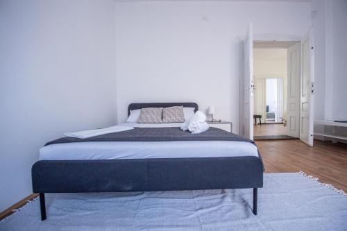 a bedroom with a large bed with a blue blanket at Family House in Leskovac