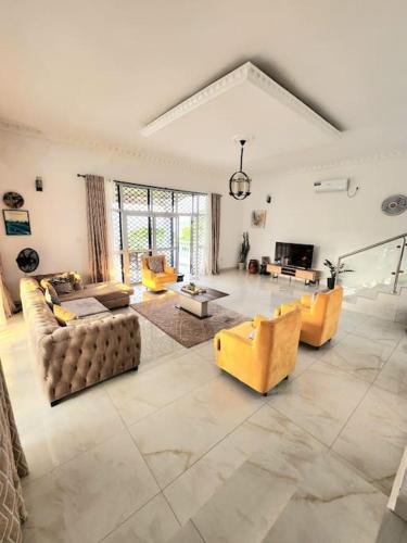 a large living room with couches and a table at Ocean Front Villa, Ngeme in Limbe