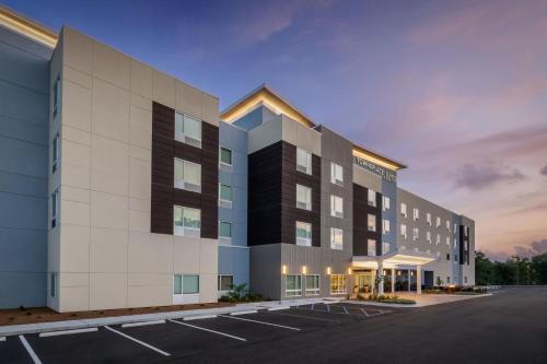 an exterior view of a building with a parking lot at TownePlace Suites by Marriott Brunswick in Brunswick