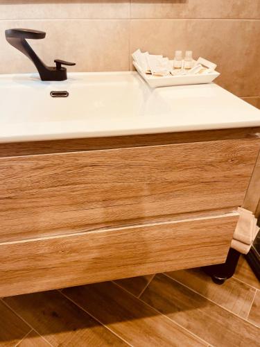 a white sink in a bathroom with a counter at Golden House-Super View On Turin in Turin