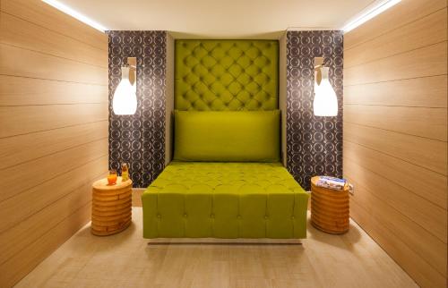 a green bench in a room with two lights at Swiss Wine by Fassbind in Lausanne