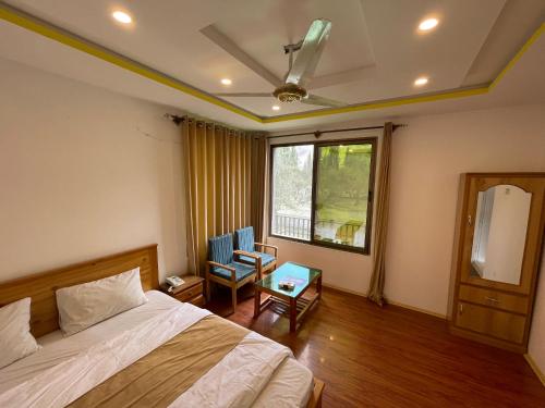 a bedroom with a bed and a window at Sarfaranga Residency in Skardu