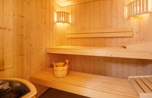 a sauna with a trash can sitting on a bench at Swiss Wine by Fassbind in Lausanne
