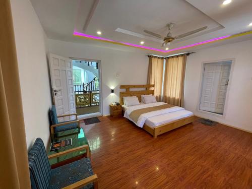 a bedroom with a bed and a wooden floor at Sarfaranga Residency in Skardu