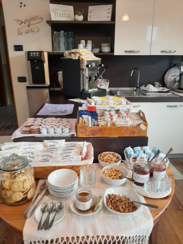 a kitchen with a table with food on it at B&B La Vecchia Tipografia - Lago D'Idro in Ponte Caffaro