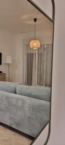 a reflection of a bedroom with a bed in a mirror at Summer Park Residence Peljesac in Orebić