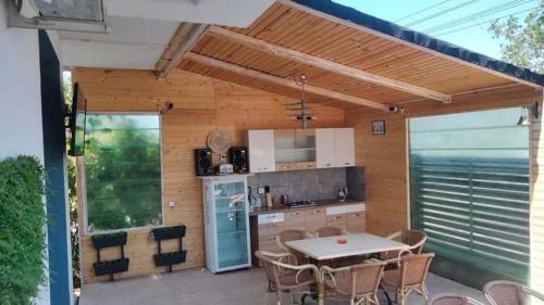 an outdoor kitchen with a table and chairs at Casa KIM in Eforie Nord