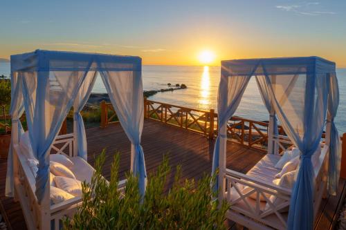 two beds on a deck watching the sunset at Atrium Prestige Thalasso Spa Resort & Villas in Lachania