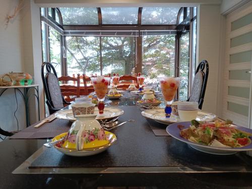 a dining table with plates of food on it at StellaMarina~海の星　ATAMI in Shimo-taga