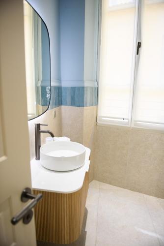 a bathroom with a sink and a mirror at Aparthotel 9 ALBERTI Nice Centre in Nice