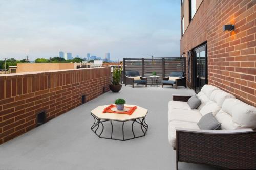 a patio with a couch and a table on a building at SpringHill Suites by Marriott Fort Worth Historic Stockyards in Fort Worth