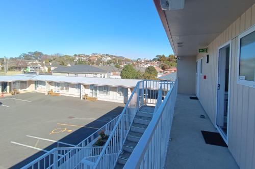 a balcony of a building with a parking lot at Bayfield Motel and Apartment in Dunedin