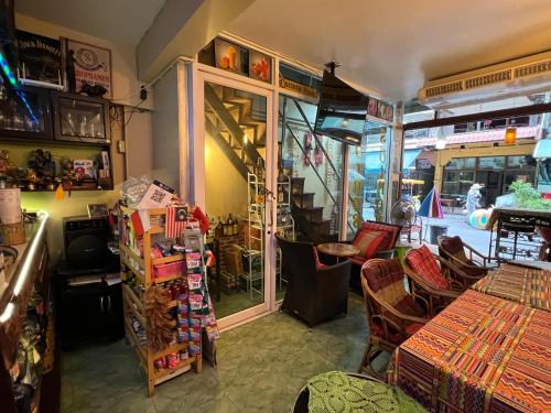 a room with a table and chairs and a staircase at Sötnos in Jomtien Beach