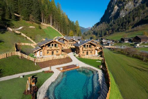 an aerial view of a large house in a mountain at Chaletdorf Auszeit in Hüttschlag
