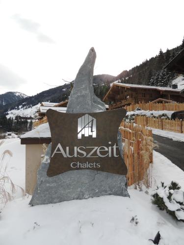 a sign for a ski resort in the snow at Chaletdorf Auszeit in Hüttschlag