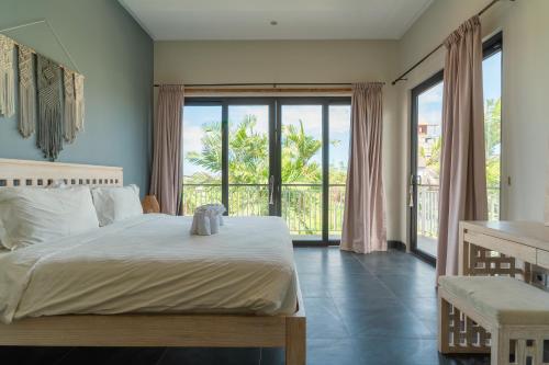 a bedroom with a bed with a view of the ocean at Villa GMT Canggu - By Bali Lyfe Venture in Canggu