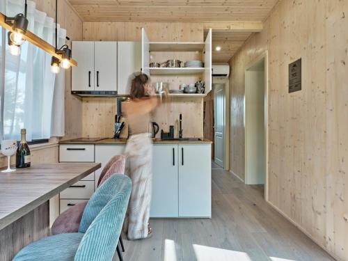 a woman standing in a kitchen with a counter at Lelis Alpenloft - Bergchalet in Halden in Mittelberg
