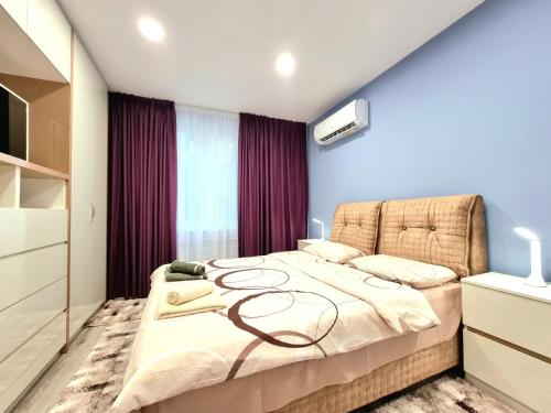 a bedroom with a large bed in a room at Alexandrovska - Super Centar Luxury Apartment in Burgas City
