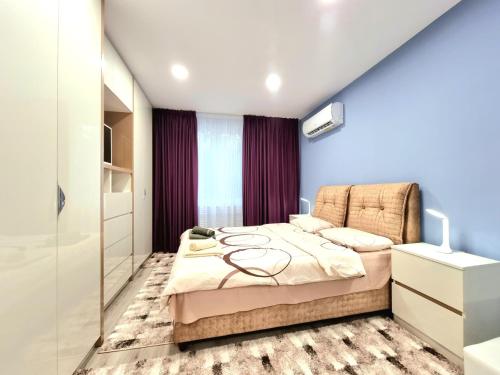 a bedroom with a bed in a room at Alexandrovska - Super Centar Luxury Apartment in Burgas City
