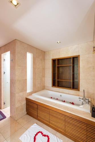 a large bathroom with a tub and a window at Emblem Sea 3 bedroom villas in Danang