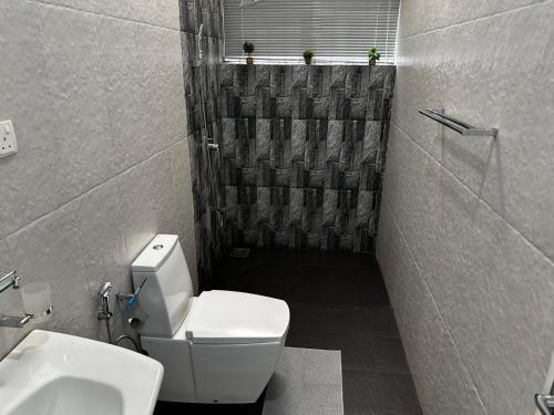 a bathroom with a toilet and a sink at Spacious Eco House with Garden and Scenic Paddy View Colombo in Malabe
