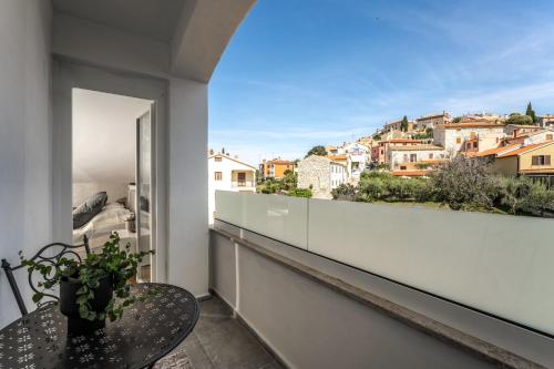a balcony with a table and a view of a city at Apartment Vala Vrsar in Vrsar