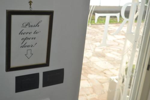 a picture hanging on a wall next to a table at Relais Tiaré Bed and Breakfast in Bacoli