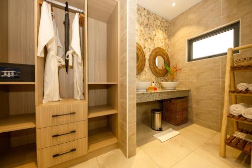 a bathroom with a sink and a mirror at Anse Boudin Chalets in Anse Possession