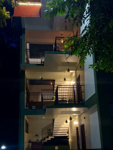 an external view of a building with stairs and lights at Lush Hills by Benchmark in Kalpetta