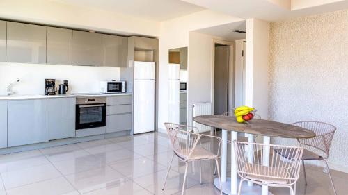 a kitchen and dining room with a table and chairs at Athens Mosaico Suites & Apartments in Athens