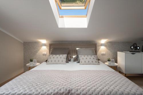 a bedroom with a large white bed with two pillows at Apartment Vala Vrsar in Vrsar