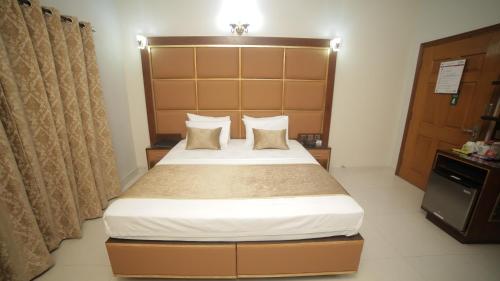 a bedroom with a large bed in a room at Four Squares by WI Hotel in Karachi