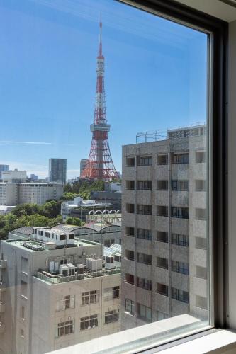 a window with a view of the eiffel tower at Section L Shimbashi West in Tokyo