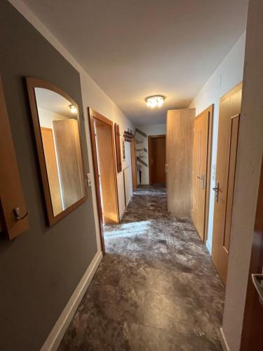 an empty hallway of a home with doors and floors at Zell Views Apartments in Zell am Ziller