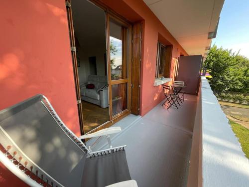 an outside balcony of a house with a window at Le Relais des Cyclamens Bron in Bron