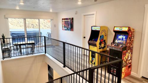 a room with two arcade games and a balcony at Terra Retreat #9 condo in Hurricane